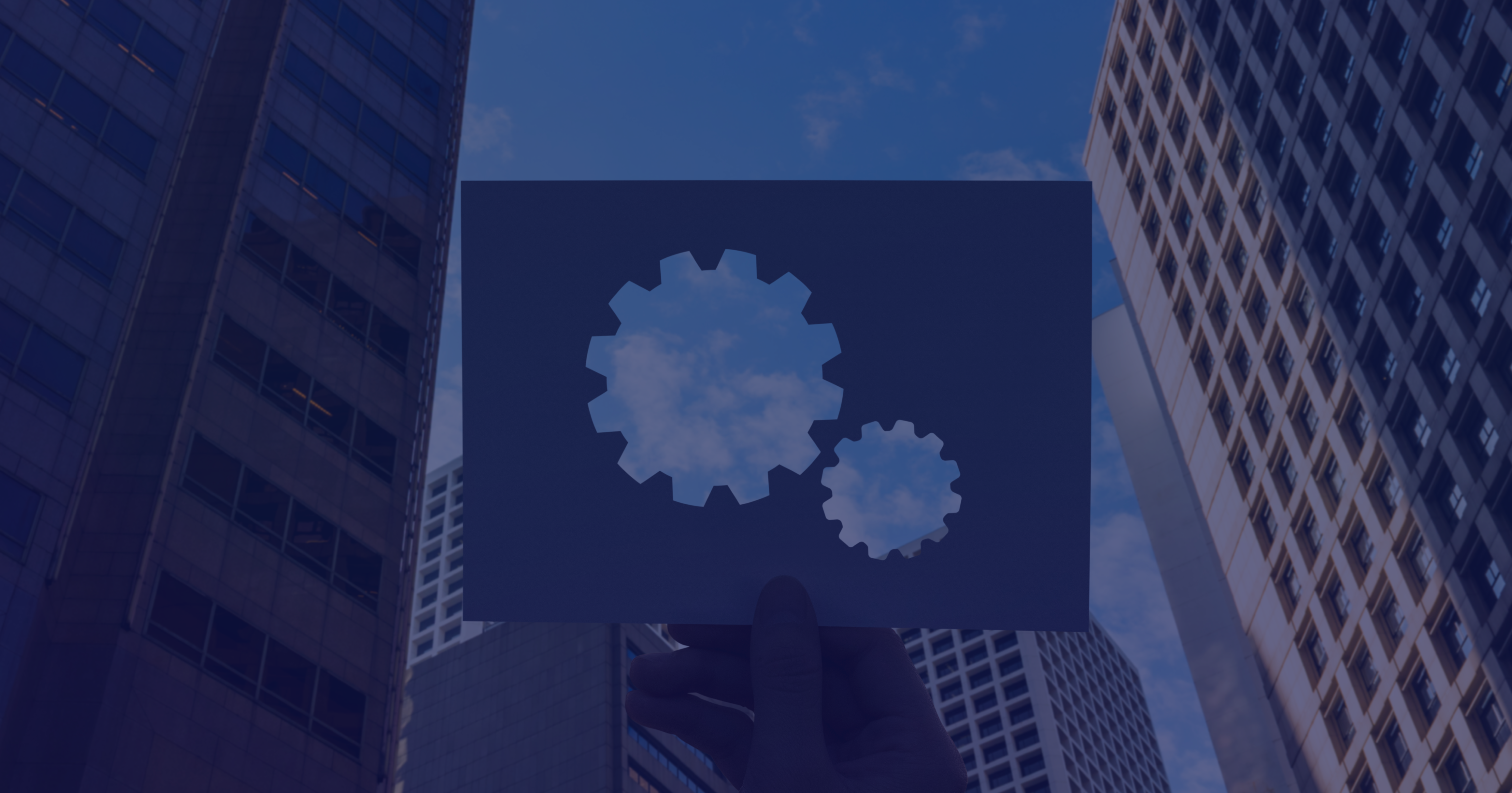 Urban skyscrapers with gear icons symbolizing DevOps integration in corporate environments