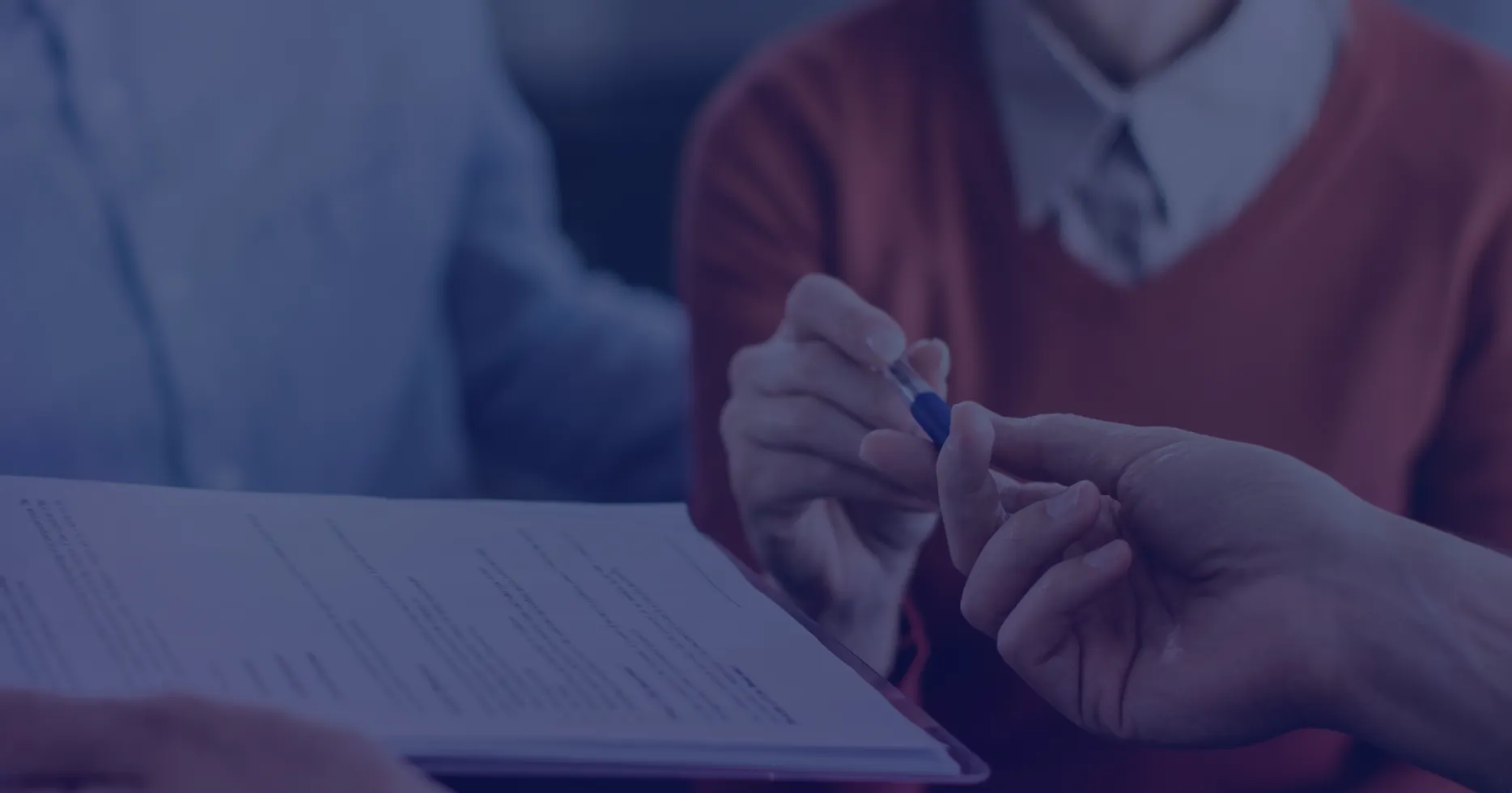 Case study: GenAI-Powered Claims Processing | Dedicatted. Hands holding pen reviewing document paperwork for claims processing, with blue overlay filter