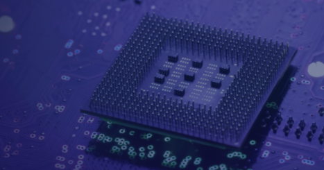 Close-up view of a computer processor with visible pins placed on a circuit board, highlighted in cool blue lighting